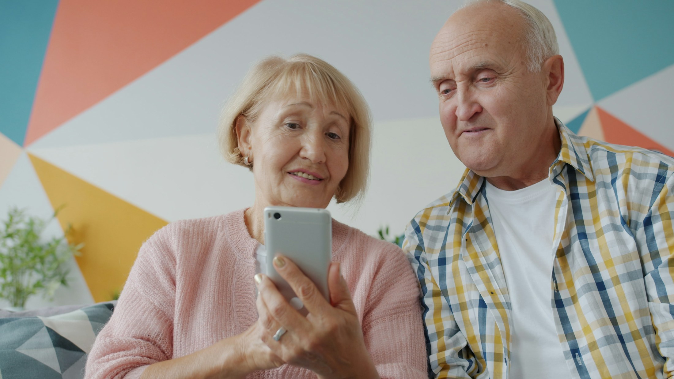 An older couple using a smartphone together